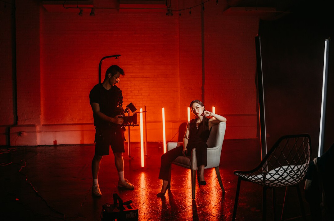 Camera operator filming in a professional television studio